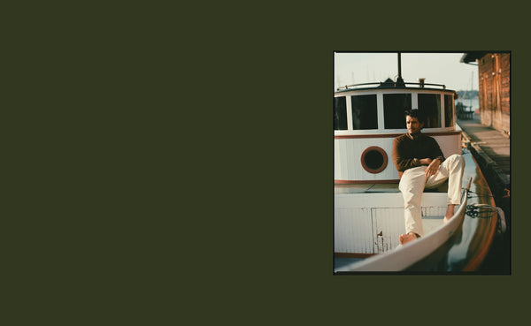 Model sitting on the deck of a boat