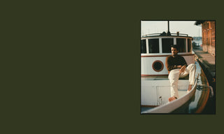 Model sitting on the deck of a boat