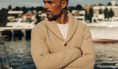 fit model posing in The Fisherman Shawl Cardigan in Heather Oat Merino