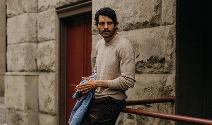 fit model posing in The Lodge Sweater in Sand Donegal