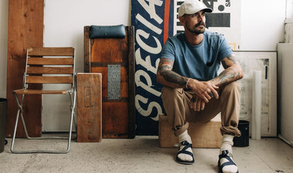 fit model sitting wearing The Organic Cotton Tee in Dyed Indigo