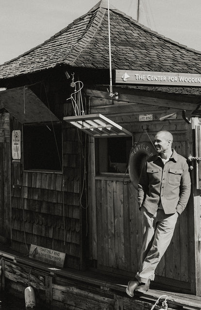 Model leaning against the exterior of The Center For Wooden Boats.