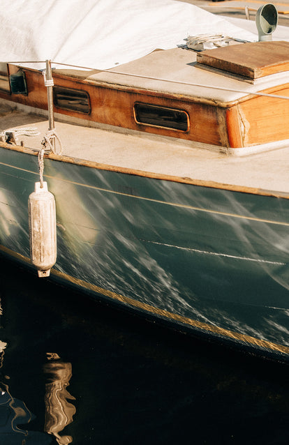 The weathered hull of a wooden boat.