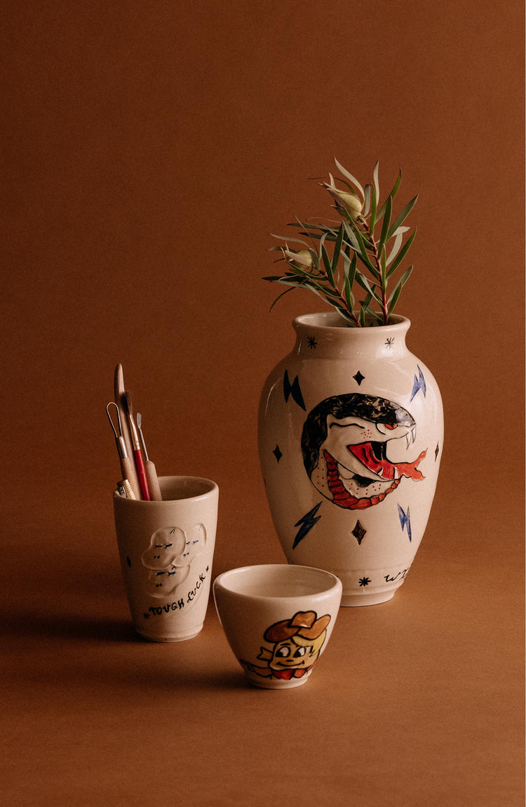 editorial image of The Lil' Cowboy Cortado Cup next to other ceramics