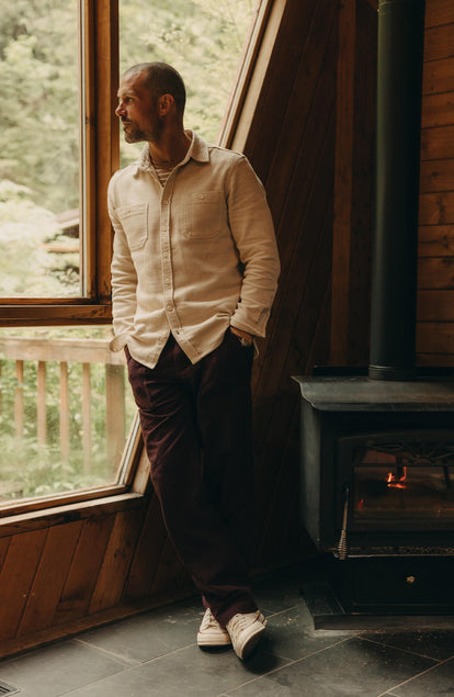 fit model leaning against the wall wearing The Breakwater Pant in Nutmeg Donegal