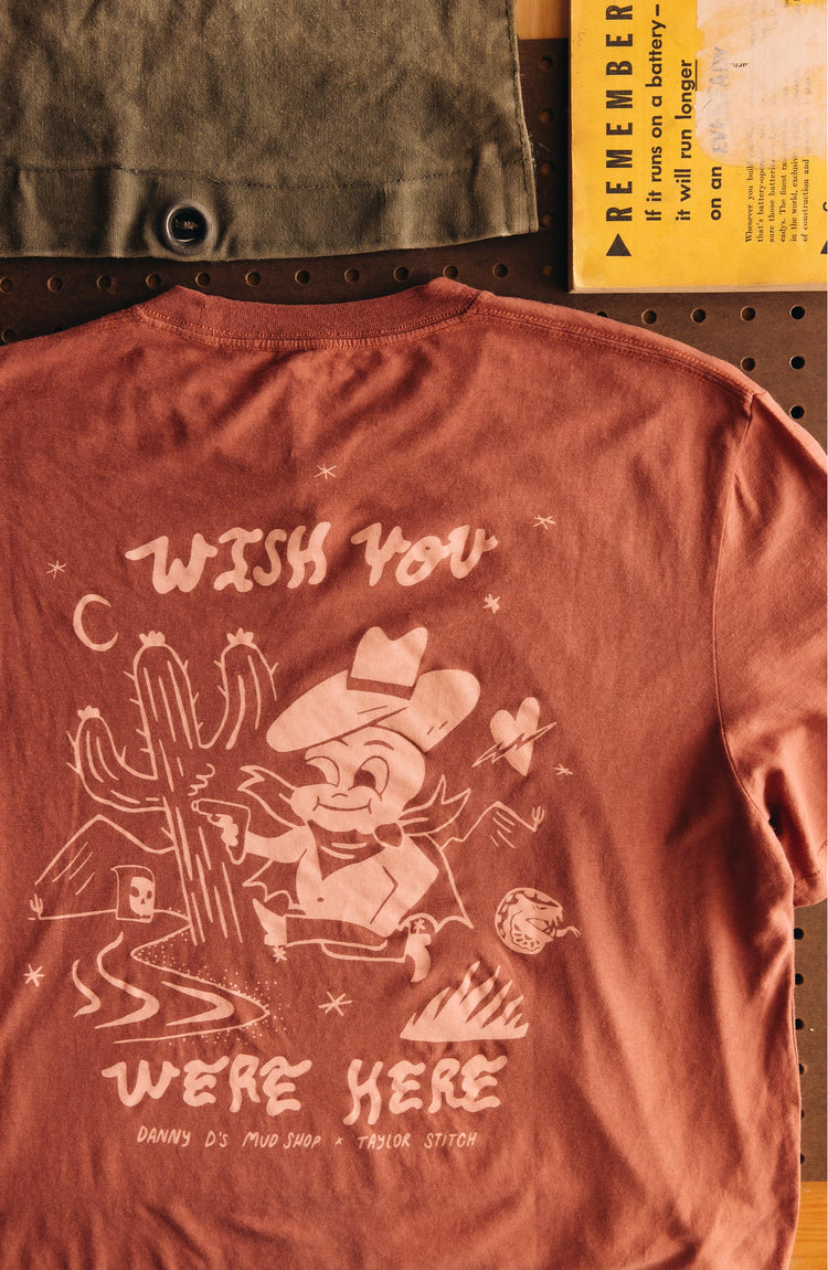 editorial image of The Cotton Hemp Tee in Wish You Were Here on a hanger