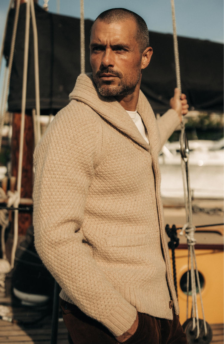 fit model posing in The Fisherman Shawl Cardigan in Heather Oat Merino