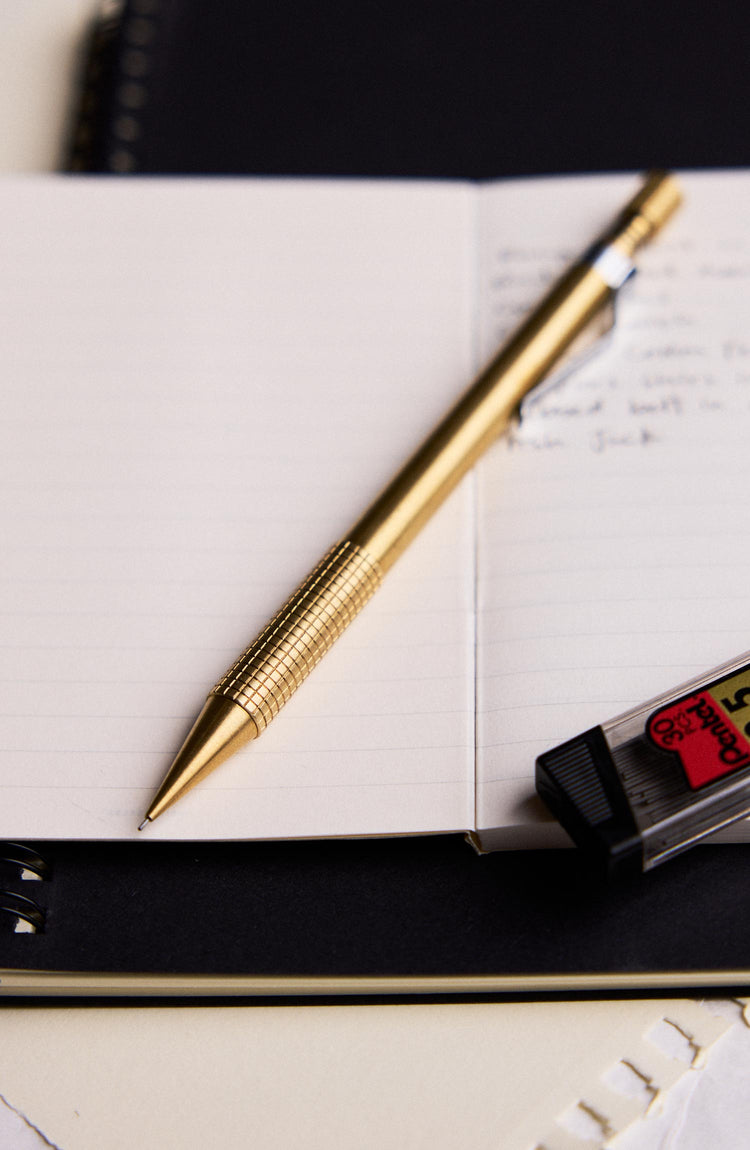 editorial image of The Mechanical Pencil in Brass on a sheet of paper