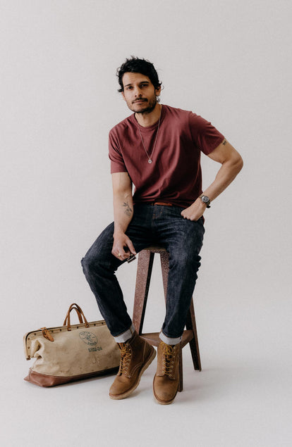 fit model sitting wearing The Organic Cotton Tee in Dried Cherry