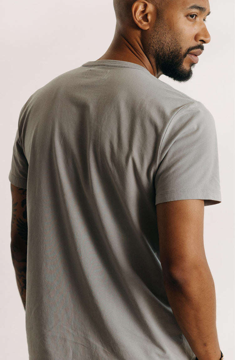 fit model showing off the back of The Organic Cotton Tee in Overcast