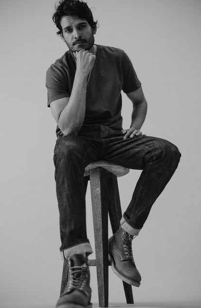 fit model sitting wearing The Slim Jean in Rigid Organic Selvedge