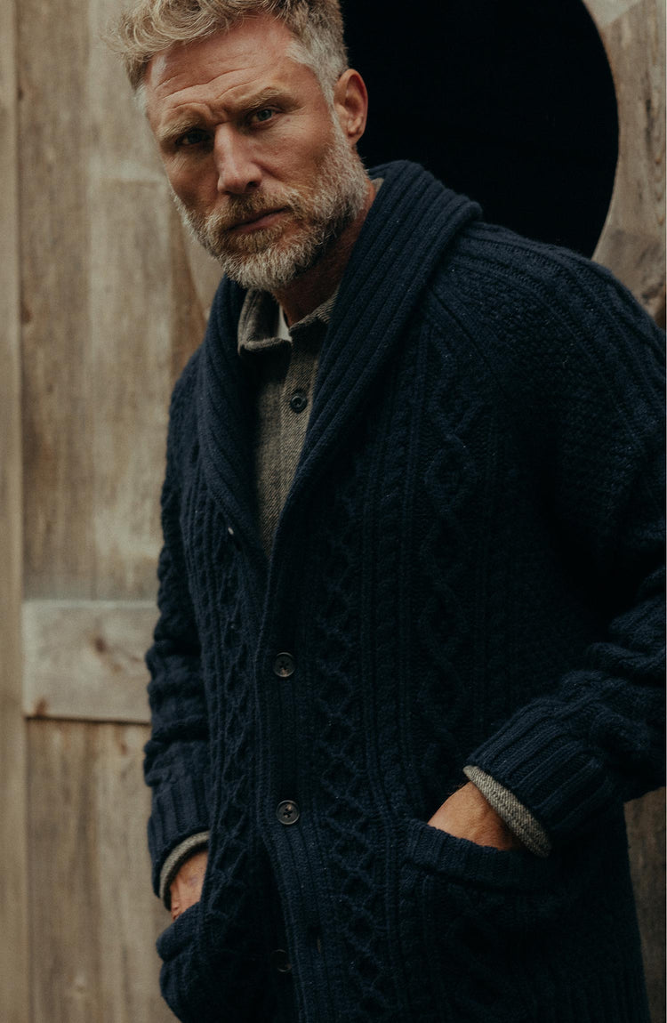 fit model with his hands in his pockets wearing The Cascade Shawl Cardigan in Heather Marine