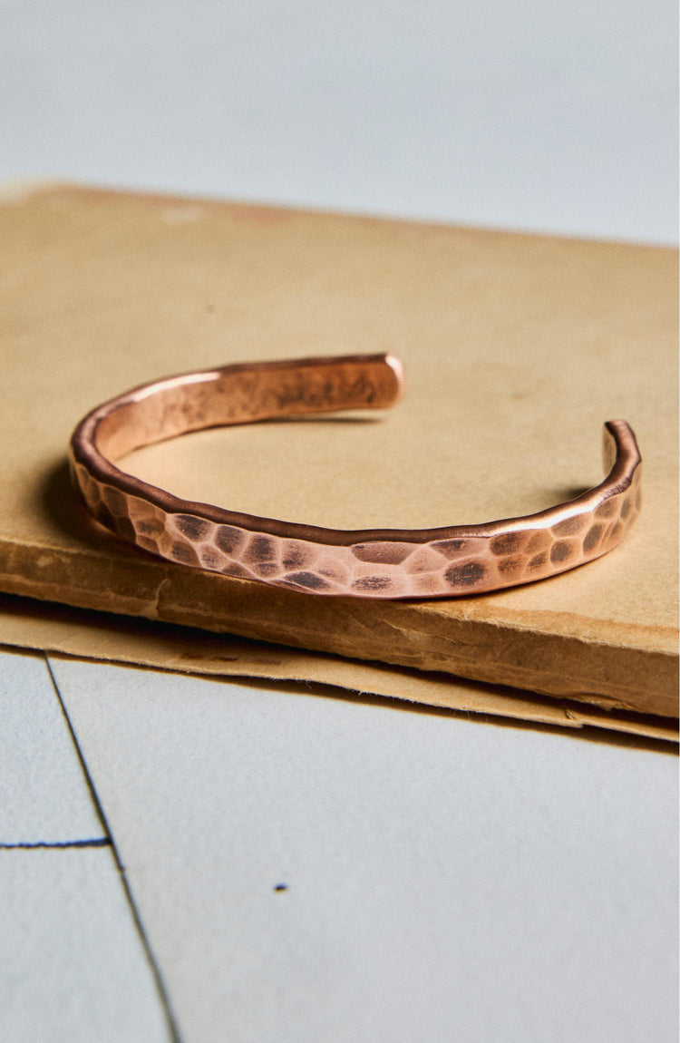 editorial image of The Hammered Cuff in Copper on a piece of paper