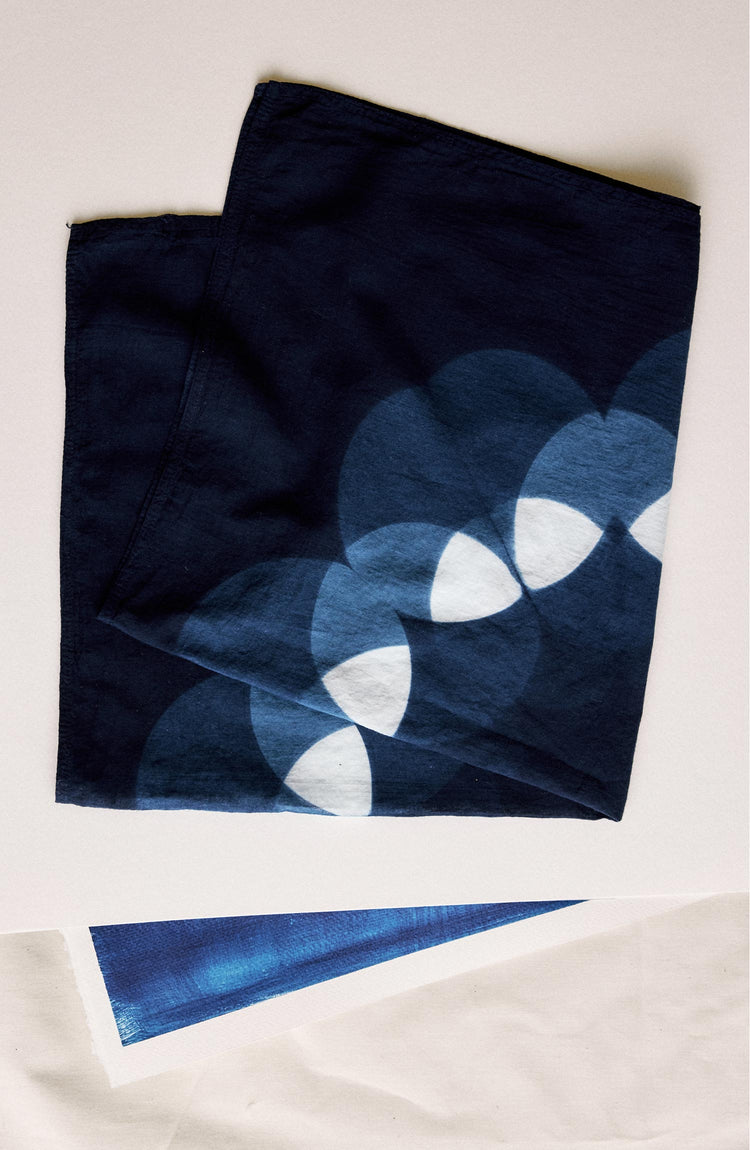 editorial flatlay of The Hand Dyed Bandana in Indigo Petal folded