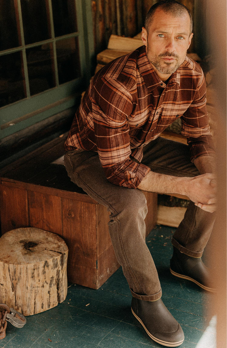 fit model sitting wearing The Ledge Shirt in Chestnut Plaid