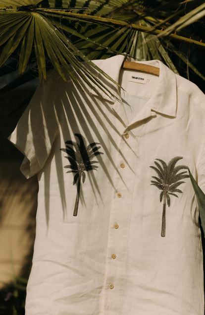 editorial image of The Short Sleeve Davis Shirt in Natural Palm Embroidery on a hanger