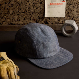 editorial image of The 5-Panel Cap in Washed Indigo next to tools, Accessories by Taylor Stitch