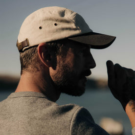 fit model posing in The 5-Panel Cap in Stone Pigment Canvas, Accessories by Taylor Stitch