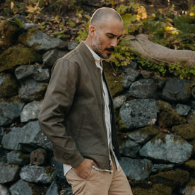 fit model walking wearing The Bomber Jacket in Fatigue Olive Dry Wax, Outerwear by Taylor Stitch