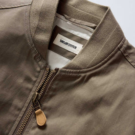 material shot of the collar on The Bomber Jacket in Fatigue Olive Dry Wax, Outerwear by Taylor Stitch