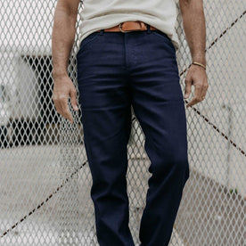 fit model leaning against the wall wearing The Camp Pant in Rigid Indigo Sashiko, Bottoms by Taylor Stitch