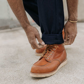 fit model adjusting the cuffs on The Camp Pant in Rigid Indigo Sashiko, Bottoms by Taylor Stitch