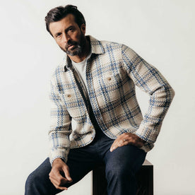 fit model sitting wearing The Cutter Overshirt in Sandbar Plaid, Wovens by Taylor Stitch