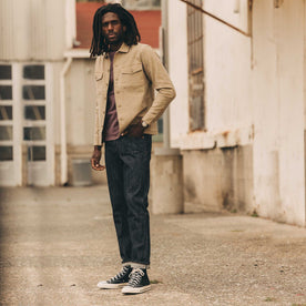 fit model posing in The Democratic Jean in Rigid Organic Selvedge, Bottoms by Taylor Stitch