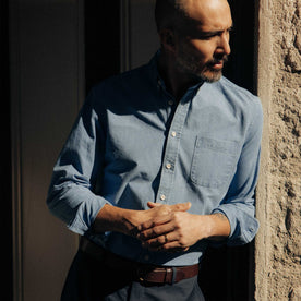 fit model leaning against the wall wearing The Jack in Washed Indigo Oxford, Wovens by Taylor Stitch