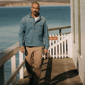 fit model walking wearing The Milton Pullover in Washed Selvedge Denim, Wovens by Taylor Stitch