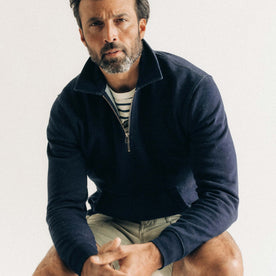 fit model sitting wearing The Apres Quarter Zip in Rinsed Indigo Terry, Knits by Taylor Stitch