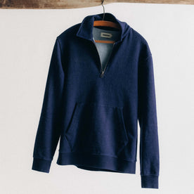 editorial image of The Apres Quarter Zip in Rinsed Indigo Terry hanging, Knits by Taylor Stitch