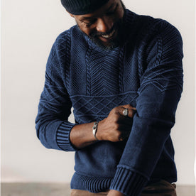 fit model adjusting the sleeves on The Bedford Sweater in Navy, Knits by Taylor Stitch