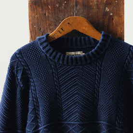 editorial image of The Bedford Sweater in Navy hanging, Knits by Taylor Stitch