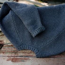 editorial image of The Fisherman Sweater in Blue Melange on a chair, Knits by Taylor Stitch