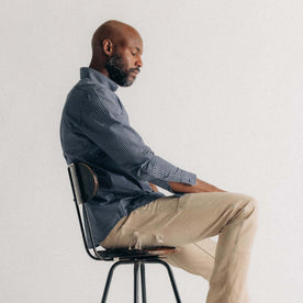 fit model sitting wearing The Jack in Marine Check, Wovens by Taylor Stitch