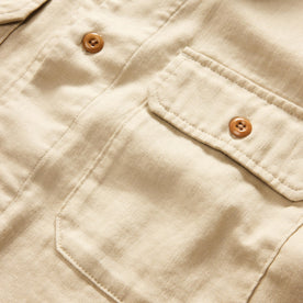 material shot of the buttons and pocket on The Short Sleeve Officer Shirt in Dune Double Cloth, Wovens by Taylor Stitch