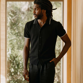 fit model with his hand in his pocket wearing The Button Down Polo in Coal Herringbone, Knits by Taylor Stitch