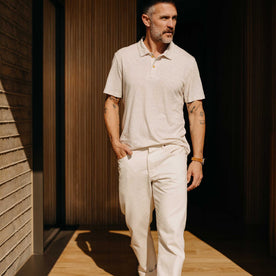 fit model walking wearing The Cotton Hemp Polo in Heather Oat, Knits by Taylor Stitch