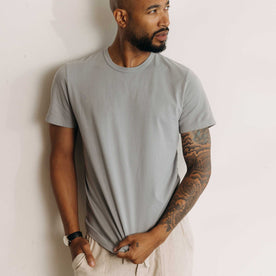 fit model against the wall wearing The Organic Cotton Tee in Overcast