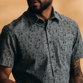 fit model showing off the buttons on The Short Sleeve California in Blue Chambray Botanical