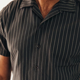 fit model showing off the buttons on The Short Sleeve Davis Shirt in Kelp Stripe