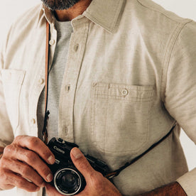 fit model holding a camera wearing The Utility Shirt in Natural Nep, Wovens by Taylor Stitch