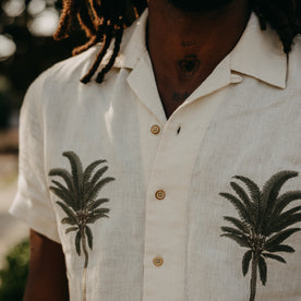 fit model showing off the palm tree detailing on The Short Sleeve Davis Shirt in Natural Palm Embroidery, Wovens by Taylor Stitch