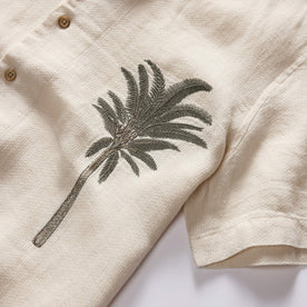 material shot of the palm tree embroidery on The Short Sleeve Davis Shirt in Natural Palm Embroidery, Wovens by Taylor Stitch