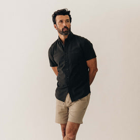 fit model posing in The Short Sleeve Jack in Faded Black Seersucker, Wovens by Taylor Stitch