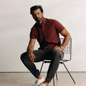 fit model sitting wearing The Short Sleeve Jack in Dried Cherry Seersucker, Wovens by Taylor Stitch