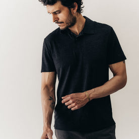 fit model posing in The Merino Polo in Heather Black, Knits by Taylor Stitch