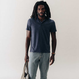 fit model standing wearing The Merino Polo in Heather Navy, Knits by Taylor Stitch