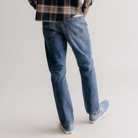 fit model showing off the back of The Democratic Jean in Mid Wash Organic Selvedge, Bottoms by Taylor Stitch